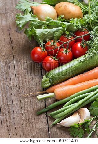 Organic Vegetables And Greens On A Wooden Table
