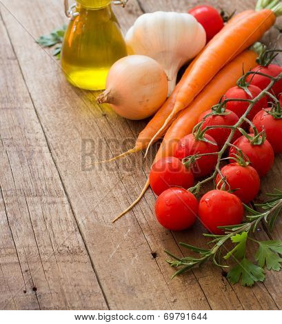 Organic Vegetables And Olive Oil On A Wooden Table