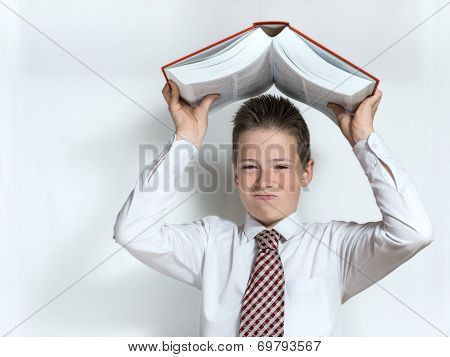 Displeased schoolboy throws big book