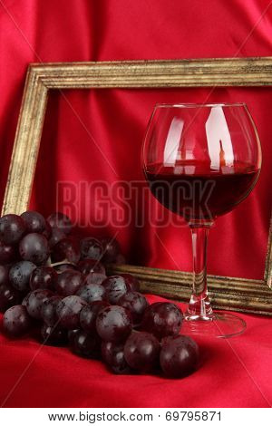 composition of frame,wine and grapes on bright background