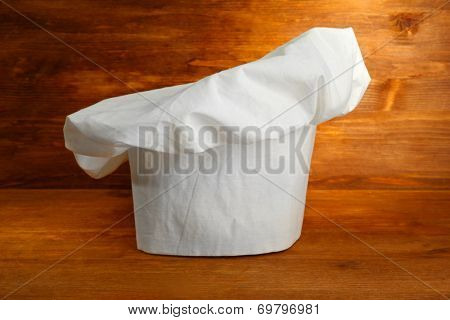 Chef's hat on wooden background