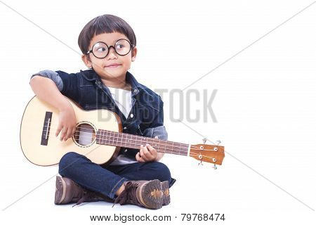 Cute boy playing the ukulele