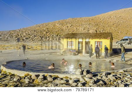 TERMAS DE POLQUES, BOLIVIA, MAY 17, 2014: Tourists take bath in hot springs in the middle of Sur Lipez desert 