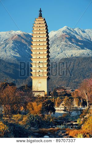 Ancient pagoda in Dali old town with snow capped Mt Cangshan, Yunnan, China.
