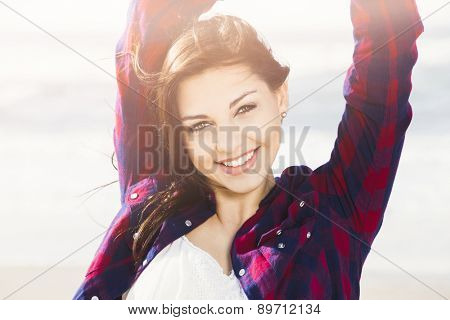 Portrtait of a happy girl at the beach smilling 