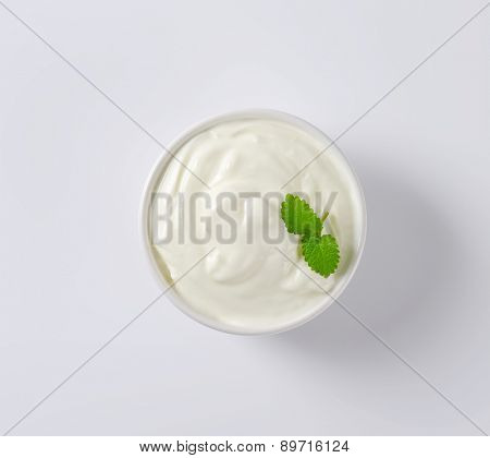 overhead view of fresh sour cream served in the bowl