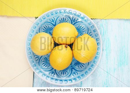 Lemons and ice cream on plates on table top view