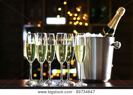 Glasses of champagne on bar background