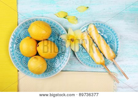 Lemons and ice cream on plates on table top view