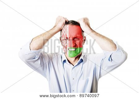 Angry mature man with Bealrus flag painted on face.