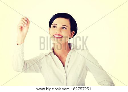 Happy businesswoman drawing on a glassboard