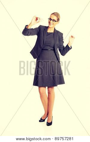 Beautiful businesswoman with plane toy in hand