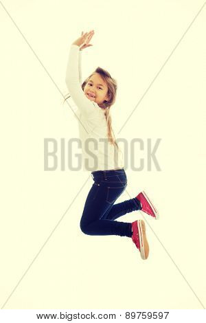 Little pretty girl jumping with joy