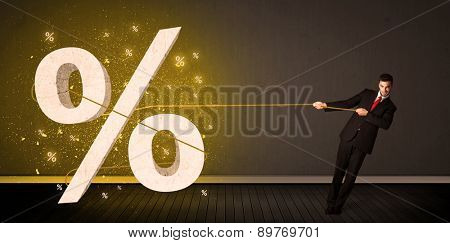 Business man pulling rope with big procent symbol sign concept on background
