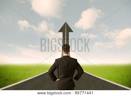 Businessman lokking at 3d road upgoing arrow concept