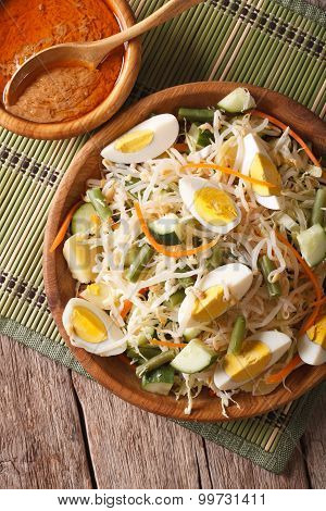 Traditional Indonesian Salad Gado-gado Closeup. Vertical Top View