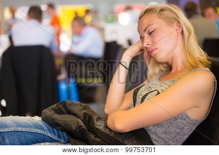 Tired female traveler waiting for departure.