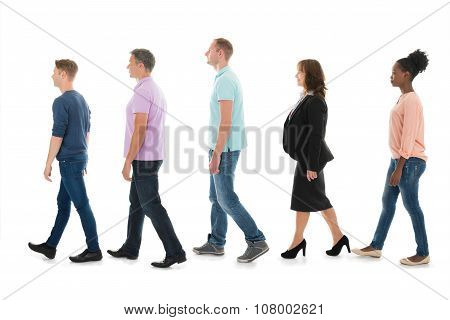 Creative Business People Walking With Manager In Row