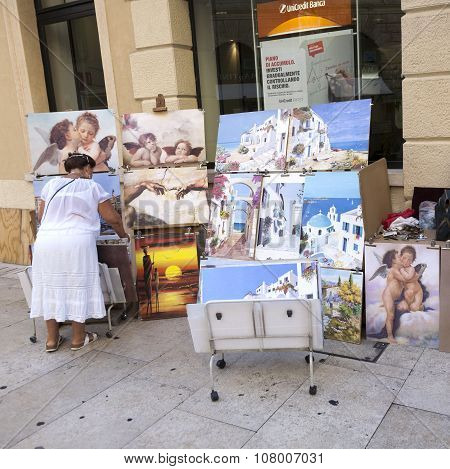 Local Woman Offers Paintings To Tourists