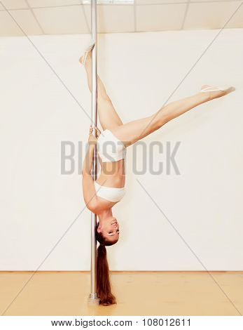 Poledance girl posing in studio