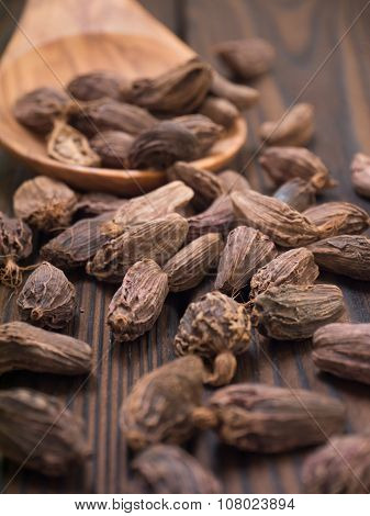 Black Cardamom Pods In The Wooden Spoon