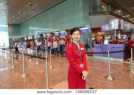 SINGAPORE - NOVEMBER 03, 2015: portrait of Cathey Pacific staff. Cathay Pacific is the largest airline of Hong Kong, with its head office and main hub located at Hong Kong International Airport