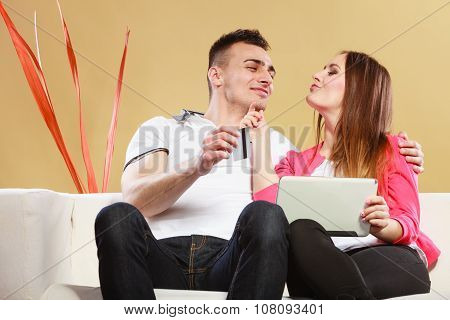 Young Couple With Tablet And Credit Card At Home