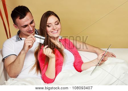 Young Couple With Tablet And Credit Card At Home