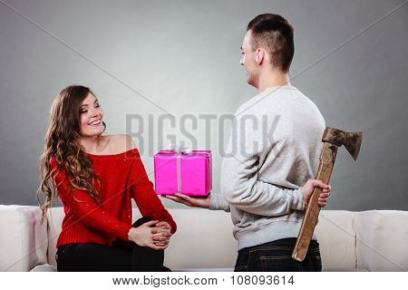 Insincire Man Holding Axe Giving Gift Box To Woman
