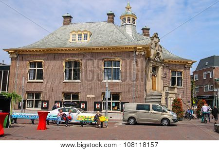 People Resting On Benches Near City Hall Of Zandvoort,  The Netherlands