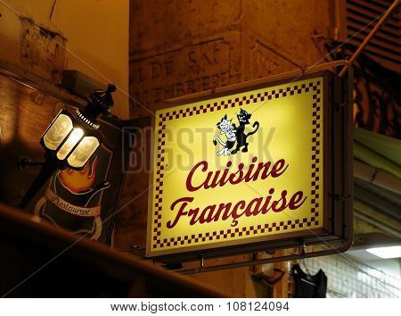 PARIS, FRANCE - SEPTEMBER 11, 2014: Latin Quarter. Narrow street of Paris among old traditional parisian houses and cafe in Paris. Famed for its nightlife Paris has about 40 000 restaurants