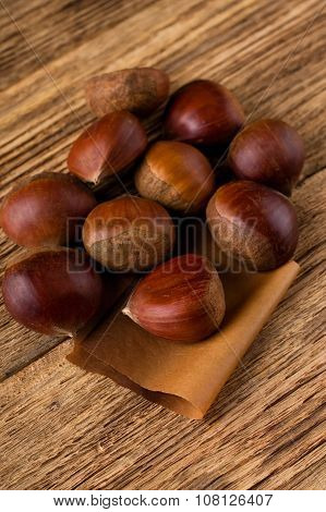 Several Sweet Chestnuts On Wooden Board
