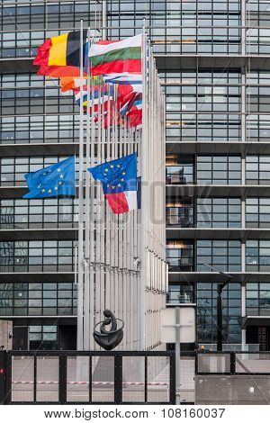 STRASBOURG, FRANCE - 14 Nov 2015: European Union Flags and France flag flies at half-mast in front of the European Parliament building following an terrorist attack in Paris