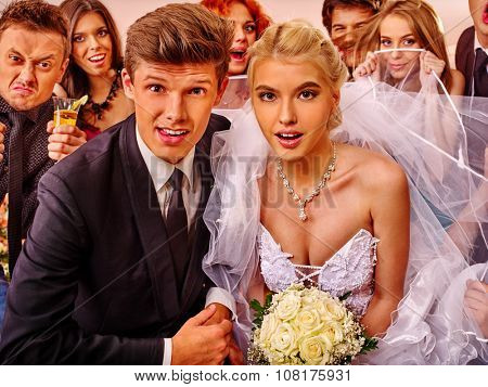 Bride and groom in photobooth making wedding pictures. .