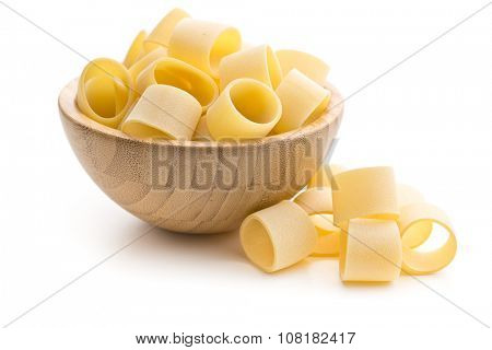 uncooked pasta calamarata in bowl on white background