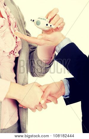 Caucasian businesswoman giving a plane to her partner.