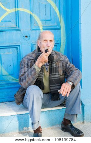 VALPARAISO - NOVEMBER 07: Unknown man in front of door in Alegre districts of the protected UNESCO World Heritage Site of Valparaiso on November 7 2015 in Valparaiso Chile