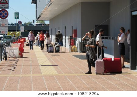 Travellers With Their Luggage At The Airport