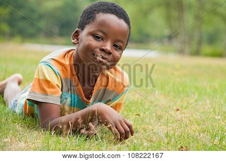African Boy Eating Grass