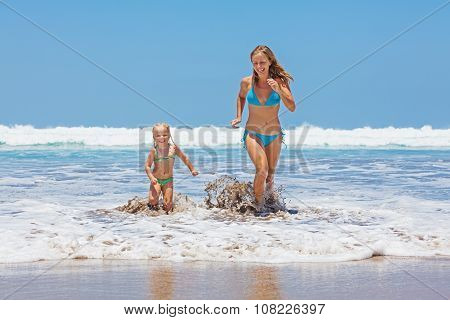 Happy Mother With Child Swim With Fun In Sea Surf