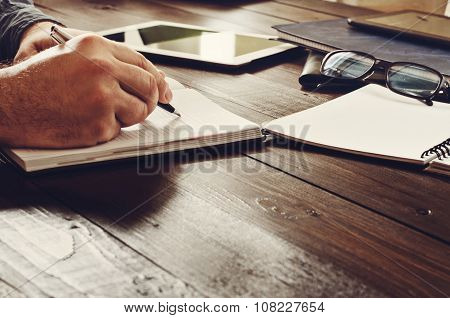 Male Hands Writing In A Notebook