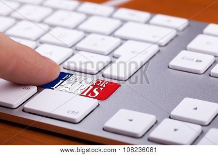 Finger Pressing On Key With Pray For Paris On National France Flag