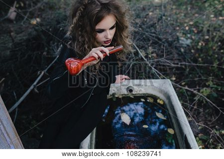 Vintage witch with elixir in hand