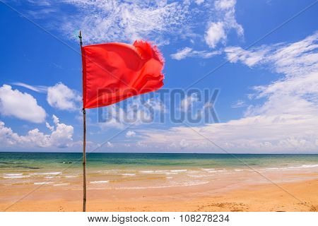 Red warning flag on beach Thailand.