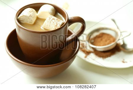 Cup of coffee with marsh mellow on a table