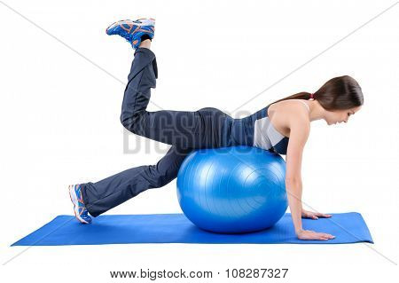 Young woman shows starting position of Fitness Stability Ball Glute Kickback Workout, isolated on white