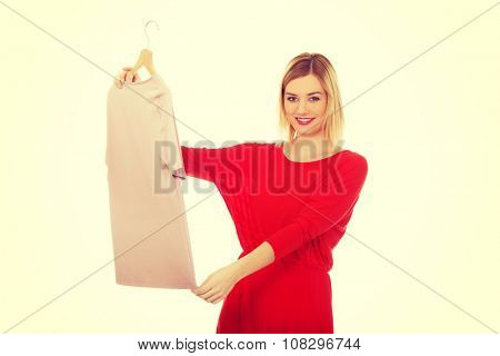 Beautiful woman thinking what to wear.
