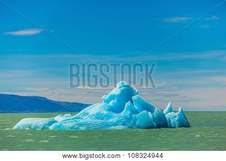 Argentina Patagonia, emerald water of the lake Viedma. Huge white-blue ice floe drifts from coastal glacier