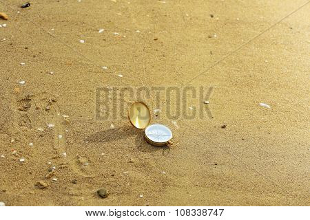 Compass on sand beach background