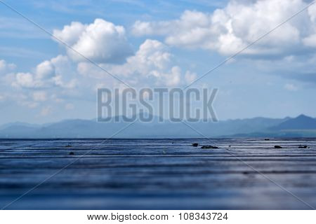 Wood Floor With Mountain And Cloud Background